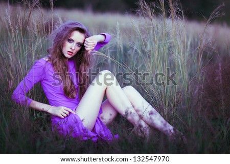 Young woman outdoors fashion portrait. Violet dress