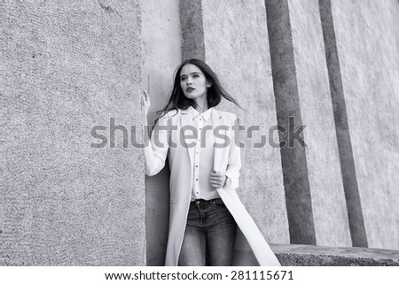 high fashion portrait of young elegant woman outdoor in jacket, blouse, jeans. Black and white image