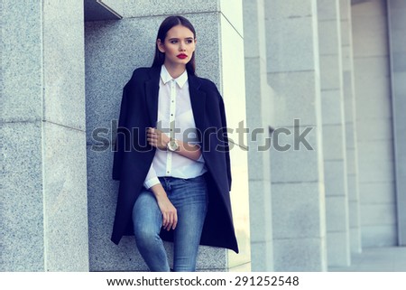 high fashion portrait of young elegant woman outdoor in blue jacket, blouse, jeans.