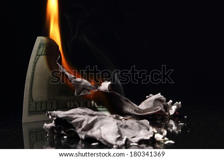 One hundred dollars in fire, burning dollar, ashes