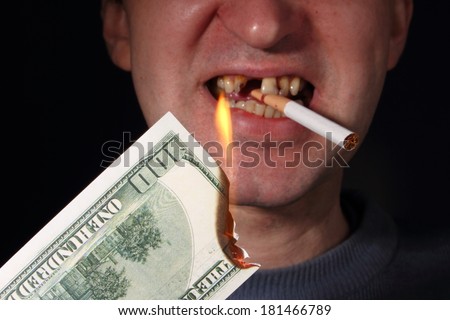 smoker with burning dollar