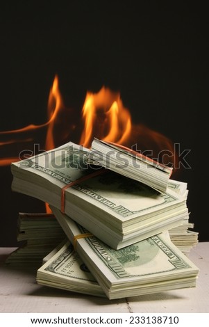 Crisis. One hundred dollars in fire, burning dollar, ashes