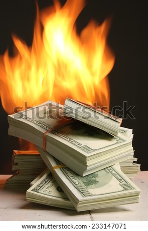 Crisis. dollars in fire, burning dollar, ashes