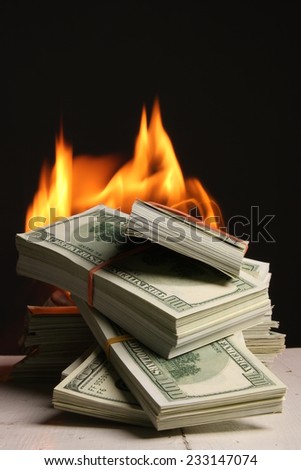 Crisis. dollars in fire, burning dollar, ashes