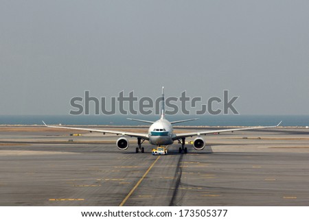 HONG KONG, CHINA - DEC 29, 2013: Cathay Pacific flight in Hong Kong International Airport. About 90 airlines operate flights from HKIA to over 150 cities across the globe.