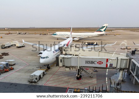 SHANGHAI, CHINA - OCT 24, 2014: Cathay Pacific and Malaysian Airlines planes are parked in Shanghai Pudong International Airport. The airport is  a major international hub for Air China.