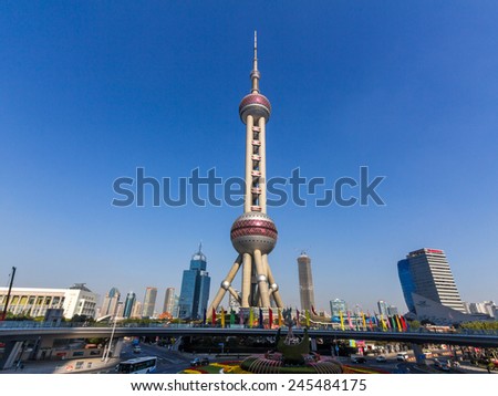 SHANGHAI, CHINA - OCT 24, 2014: The Oriental Pearl is a TV tower in Shanghai, China. It is located at the tip of Lujiazui in the Pudong district by the side of Huangpu River, opposite The Bund.