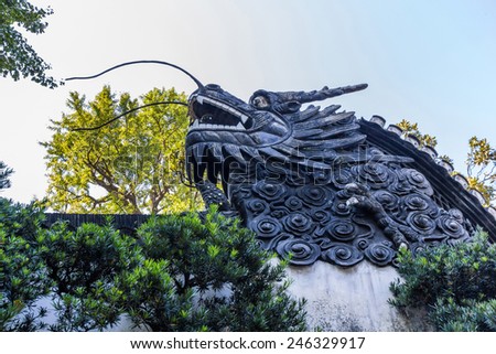 SHANGHAI, CHINA - OCT 24, 2014: Chinese Dragon on the roof in Yuyuan Garden. Shanghai, China. It located beside the City God Temple in the northeast of the Old City of Shanghai, China.