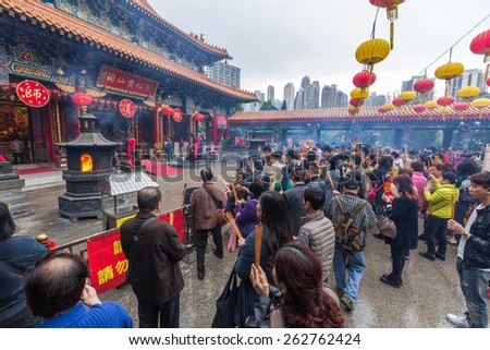 HONG KONG - MAR 10, 2014: Crowded day at Sik Sik Yuen Wong Tai Sin Temple in Hong Kong. It is one of the largest and commemorates the famous monk of yore, Wong Tai Sin also known as Huang Chu-ping.