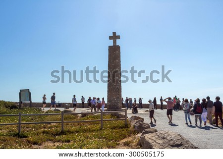 COLARES, PORTUGAL - MAY 26, 2015: The obelisk with a large white cross at Cabo da Roca (Cape Roca). It is a cape which forms the westernmost extent of mainland Portugal and continental Europe.