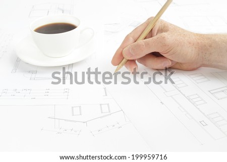Architectural background. Human hand with pencil over blueprints with sketches of projects.