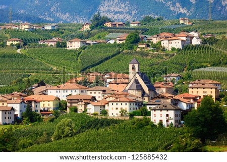 Teleshot of Tassullo town among apple gardens of italian region Trentino Alto Adige South Tyrol