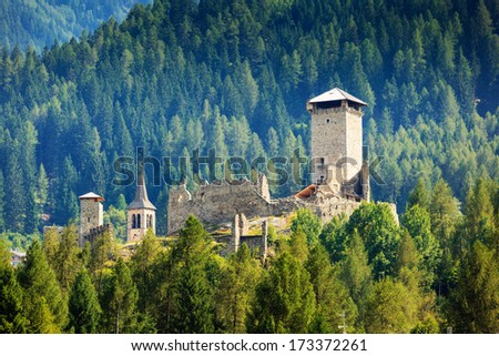 Castle San Michele of Ossana in coniferous forest of Val di Sole