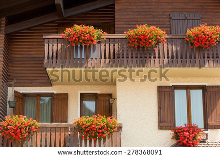 Wooden alpine villa with flowers in Madonna di Campiglio