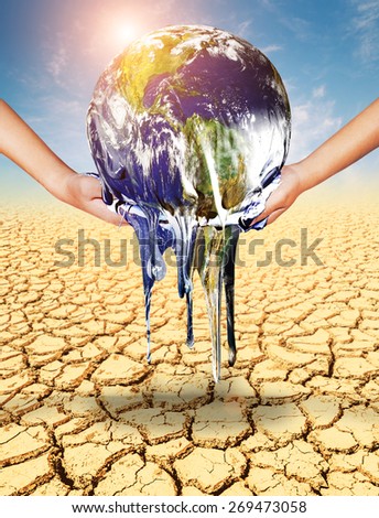 Earth melt in two hand on soil cracked .Earth day concept.Elements of this image furnished by NASA