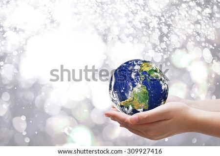 Safe world concept . Hand Holding world ball on bokeh.Copy Space on horizontal sheet.Elements of this image furnished by NASA