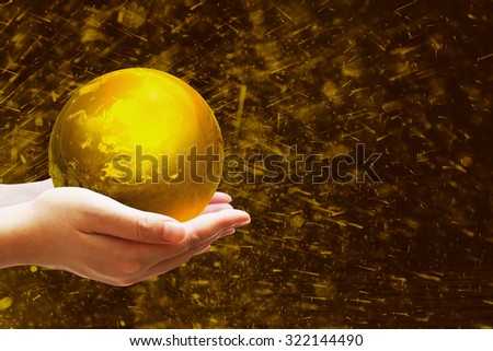 Safe world concept .Two Hand Holding the gold world on Gold bokeh background.Copy Space on horizontal sheet.Clipping path.Elements of this image furnished by NASA