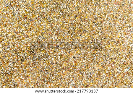 surface and texture of fine mix size gravel wall ,Tiny gravel texture on brown concrete wall in sunny day