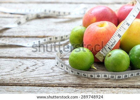 Healthy Fruit with measuring tape on wooden top , for lose weight ,Diet, Healthy lifestyle concept