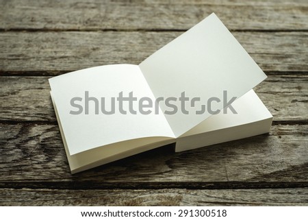 White book Open square on old wooden , abstract book