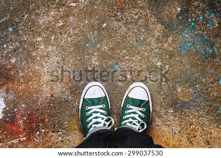 Green Sneakers shoes walking on concrete look top view , Canvas shoes on art concrete , Hister life