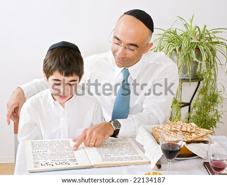 father and son celebrating passover reading the Hagada
