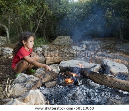 young girl in a campfire min a mediterranean forest