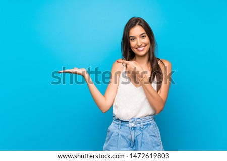 Similar – Image, Stock Photo Attractive brunette holding a smartphone laughing , beautiful sunny day. Sunset golden hour, hair glowing orange from the sun, clean blue sky