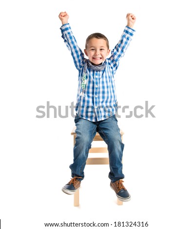 Image, Stock Photo Boy sitting on a sofa with headphones on his head and using the laptop