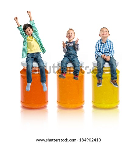 Kids on three bottle of jam over white background