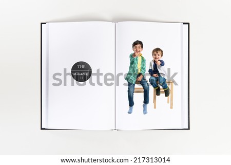 Boys pointing to the front printed on book