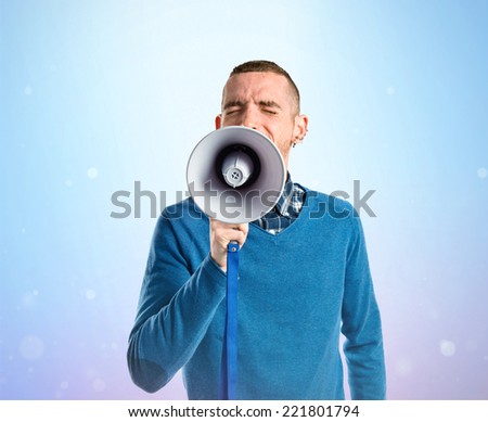 Redhead man shouting by megaphone over gloss background