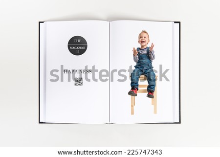 Kid sitting and clapping printed on book