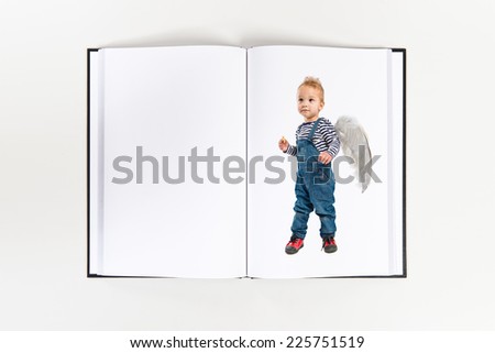 Cute kid with wings printed on book