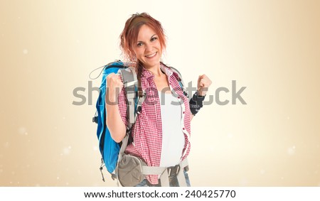 Lucky backpacker over ocher background