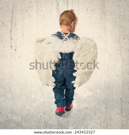 Cute kid with wings over textured background