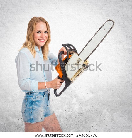 Girl with chainsaw over textured background