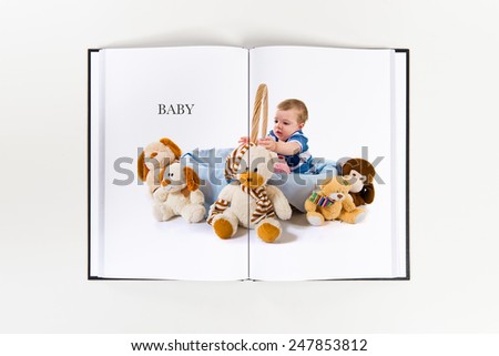 Cute baby inside basket playing with stuffed animals