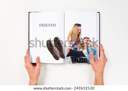Girls playing with supermarket cart printed on book
