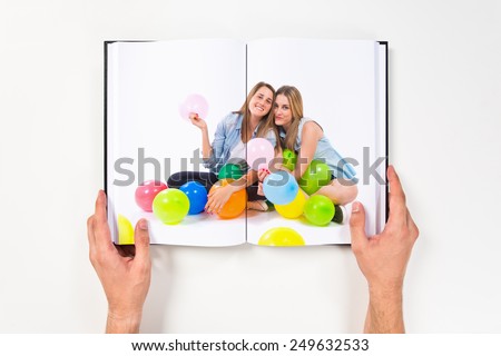 Friends with many balloons printed on book