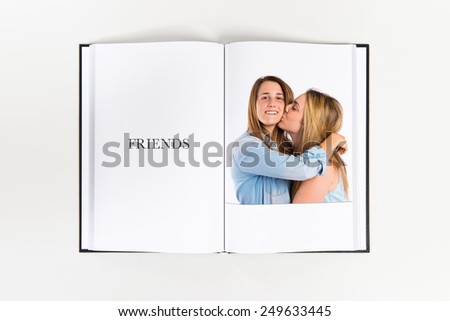 Girl giving kiss at her sister printed on book