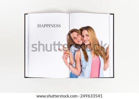 Friends doing victory gesture printed on book