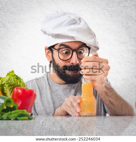 Crazy hipster chef making orange juice