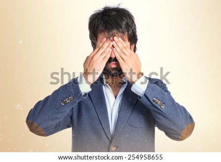 Man covering her/his eyes over isolated white background