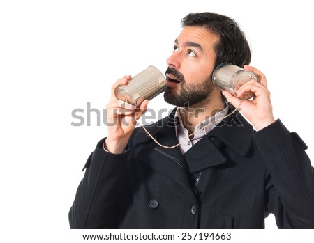 Man talking through a tin phone