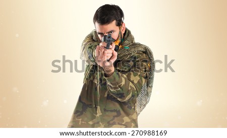 Soldier with gas mask shooting a gun