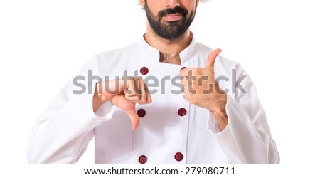 Chef making a good-bad sign over white background
