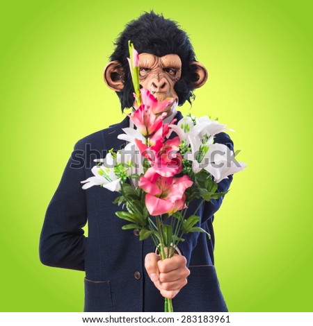 Monkey man holding a bouquet over colorful background