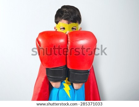 Child dressed like superhero over textured background