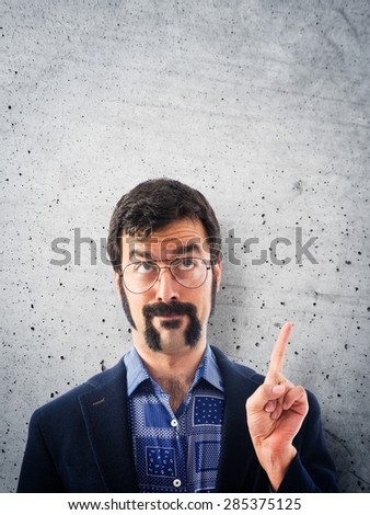 Vintage young man pointing up over textured background